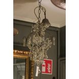 A CONTINENTAL CUT GLASS CENTRE LIGHT hung with faceted chains and pendant drops