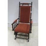 A 19TH CENTURY MAHOGANY ROCKING CHAIR with upholstered back and seat and turned frame