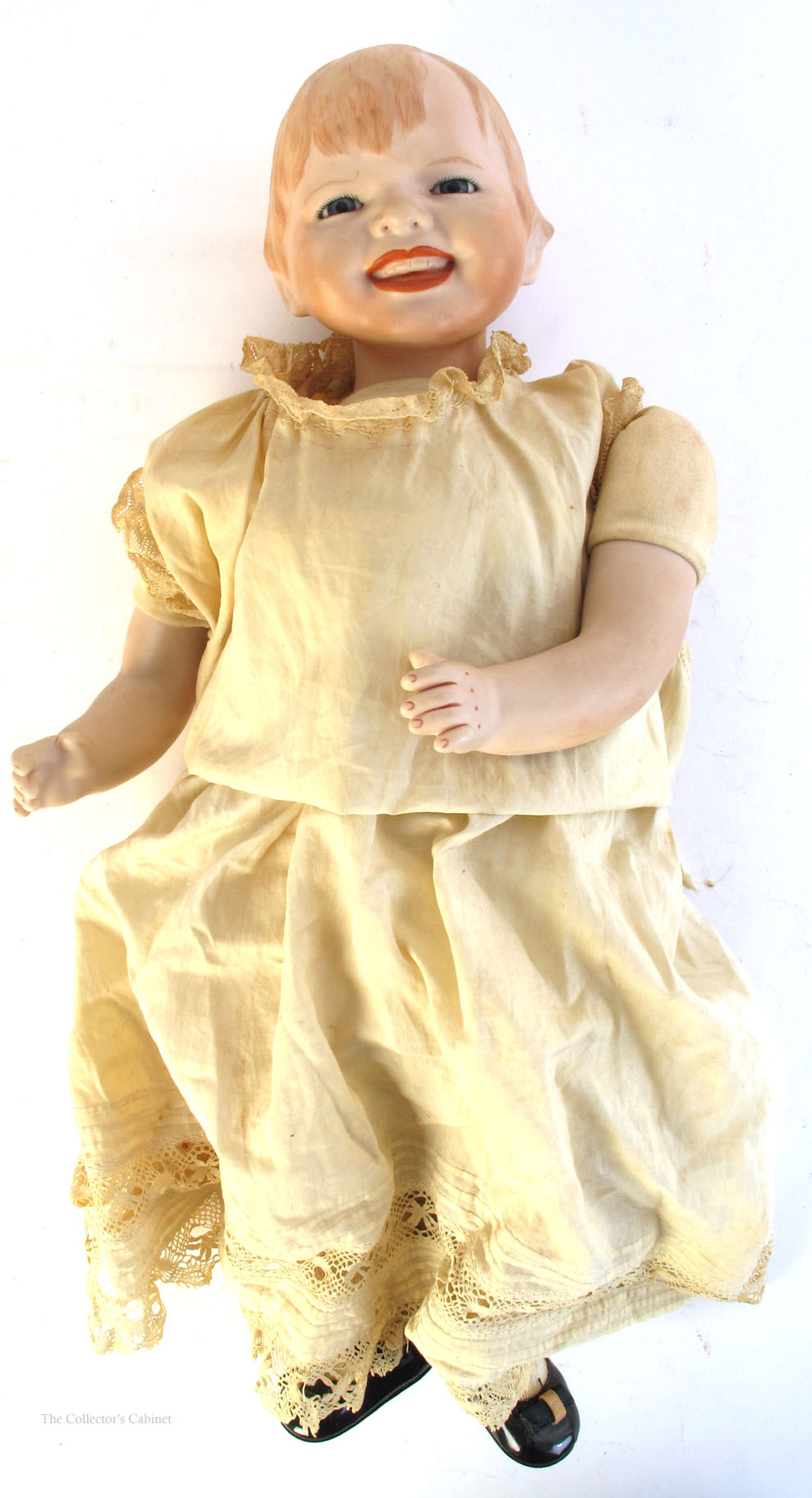 1920 A German bisque-headed baby doll, with moulded and painted hair, blue-grey glass eyes,