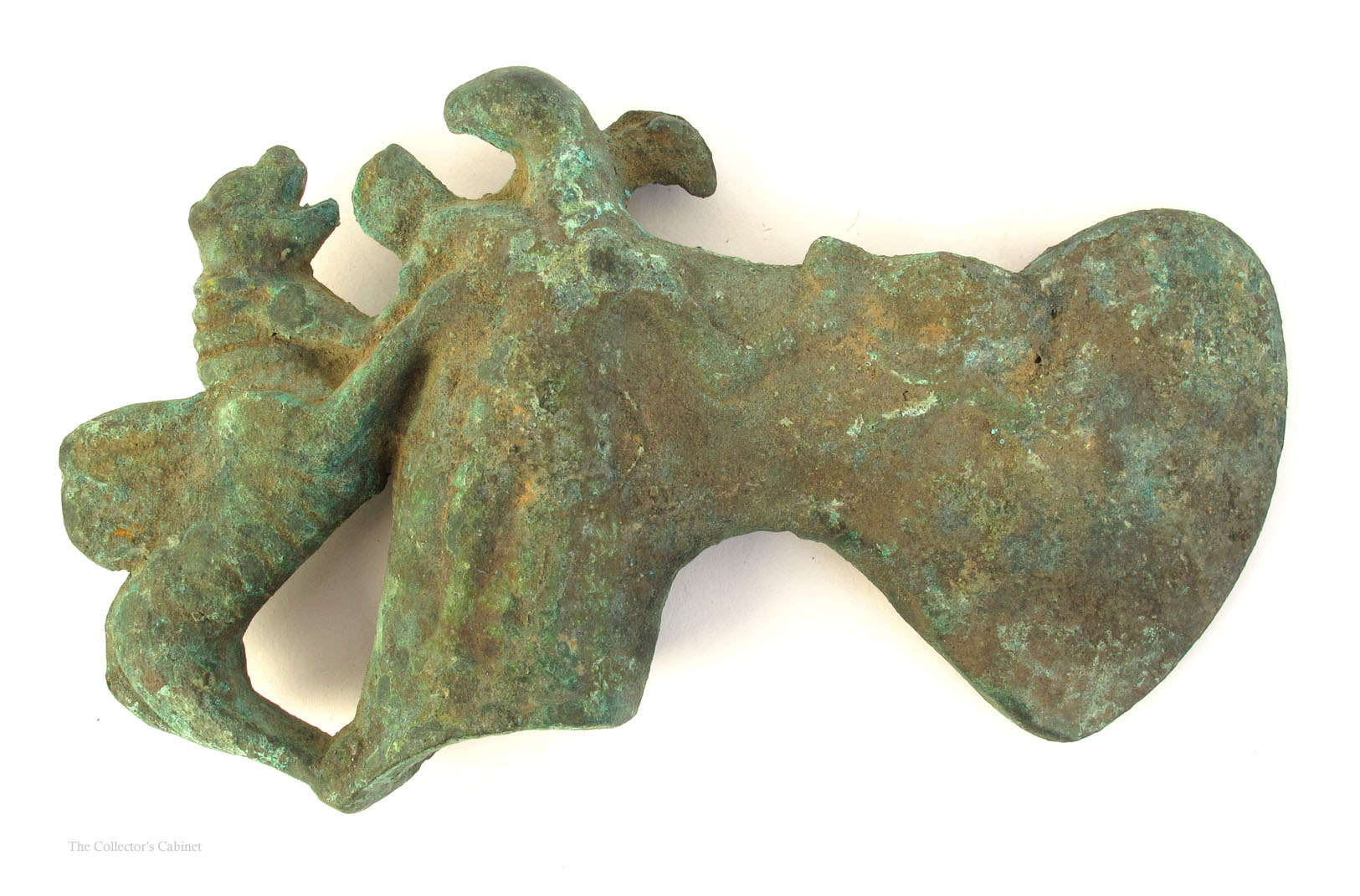 A bronze axe head, possibly Persian Luristan, the curved, broad blade,