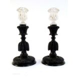 Early 19th century, a pair of carved bog oak candlesticks,