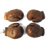 Boxing. Two pairs of brown leather boxing gloves.