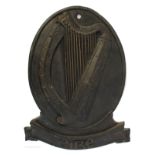 A cast iron Éire harp plaque.
