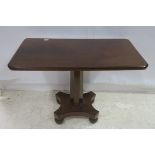 A 19TH CENTURY MAHOGANY TABLE the rectangular top above a faceted column on shaped platform base