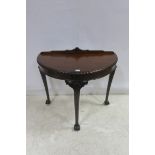 A CHIPPENDALE DESIGN MAHOGANY SIDE TABLE of demilune outline with gadrooned rim on cabriole legs