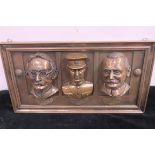 A COLDCAST WALL PLAQUE depicting Thomas J Clarke Michael Collins and James Connolly 24cm x 44cm