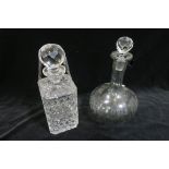 A CUT GLASS SPIRIT DECANTER WITH STOPPER together with a moulded glass decanter of bulbous outline