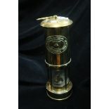 A BRASS OIL LAMP in the form of a lighthouse inscribed E Thomas and Williams Aberdare Wales 24cm