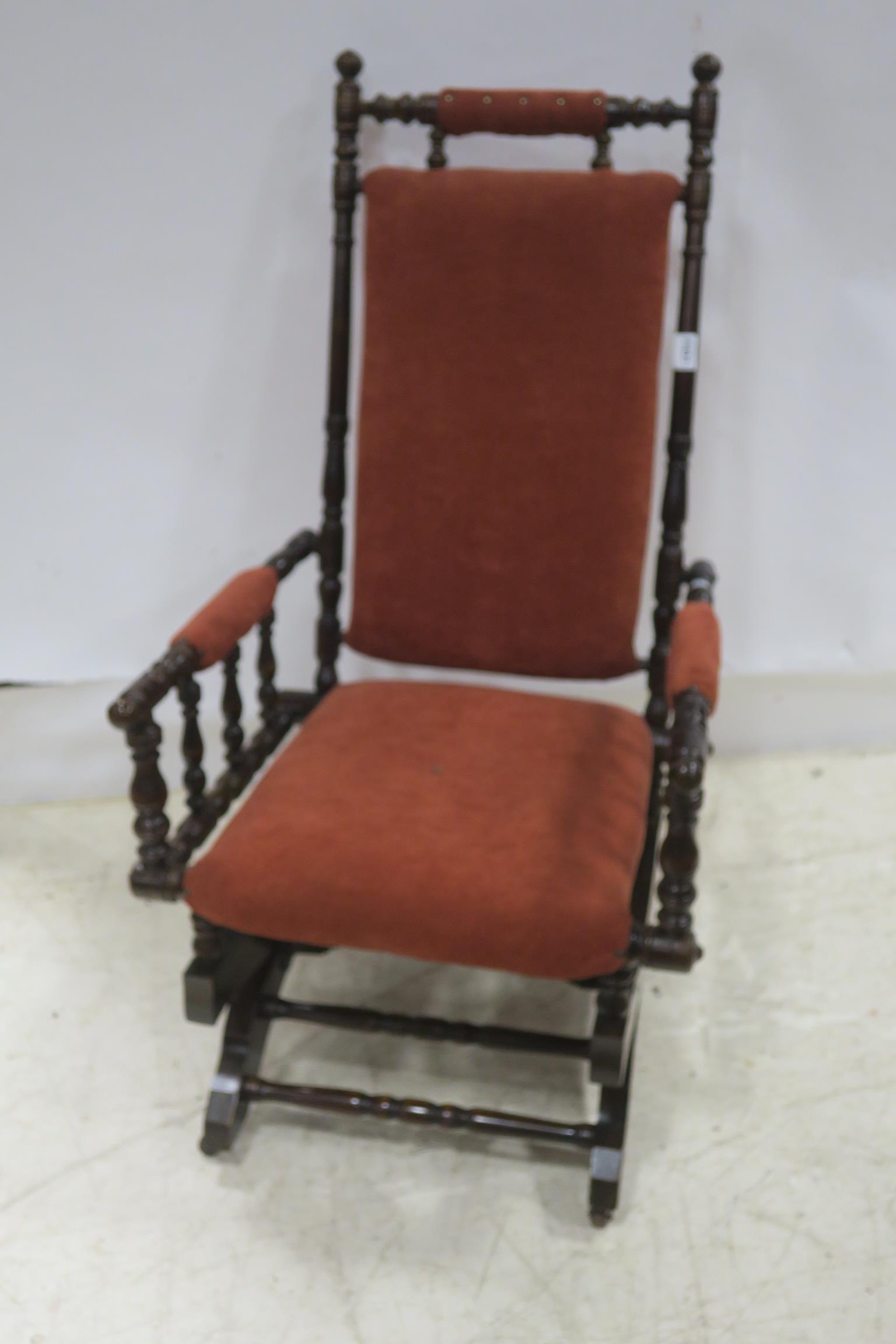 A 19TH CENTURY MAHOGANY ROCKING CHAIR with upholstered back and seat and turned frame