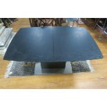 AN EBONISED BREAKFAST TABLE of rectangular outline with one loose leaf raised on a shaped pedestal