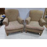 A PAIR OF VICTORIAN DESIGN UPHOLSTERED EASY CHAIRS each with a scroll over back and arms with loose