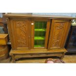 A DUTCH OAK CABINET ON STAND