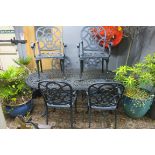 A SEVEN PIECE CAST METAL PATIO SUITE comprising six elbow chairs and table of oval outline on
