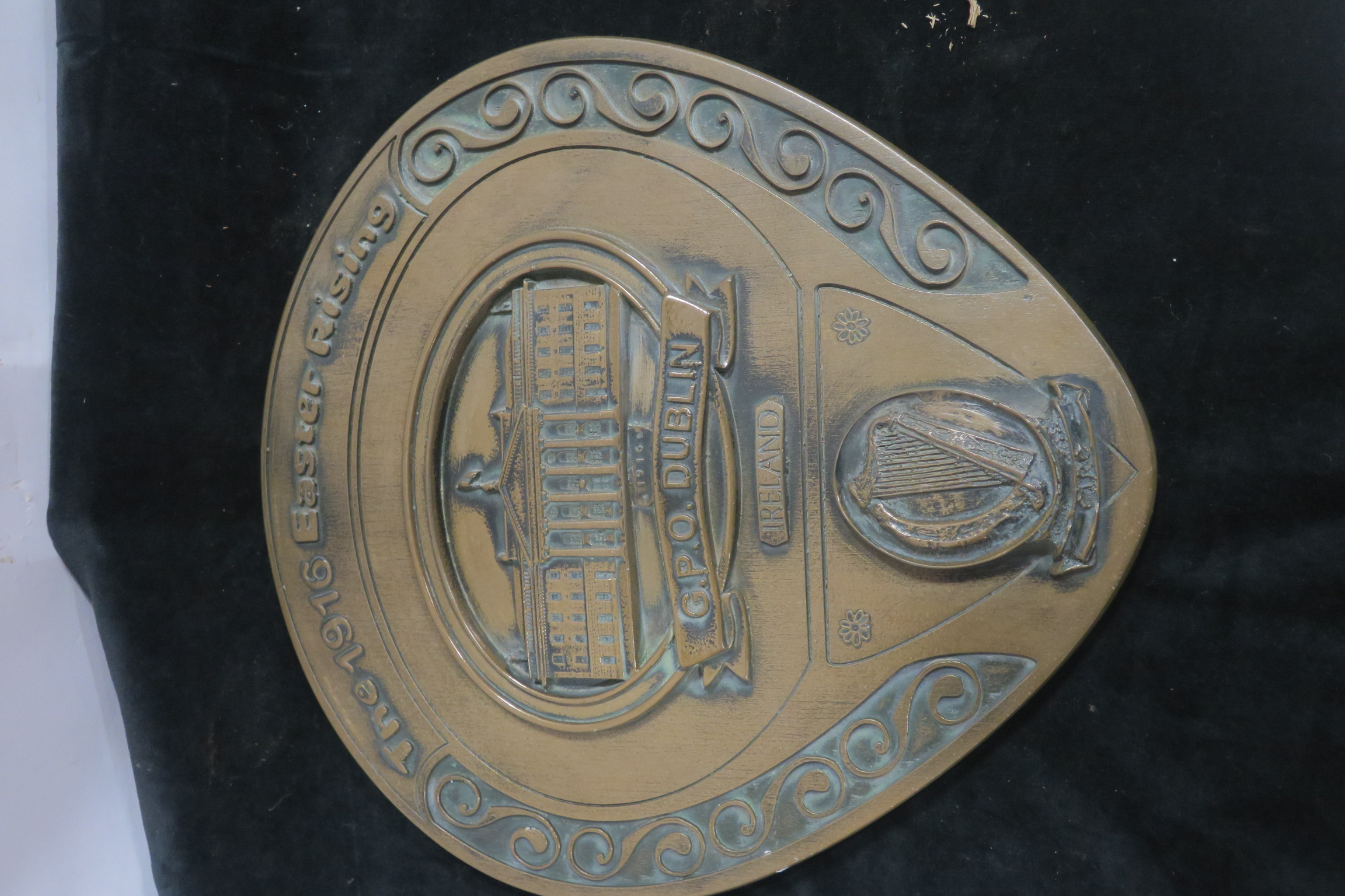 A COLDCAST WALL PLAQUE inscribed The 1916 Easter Rising GPO Dublin of circular tapering form 32cm x