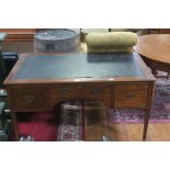 A GEORGIAN MAHOGANY DESK the rectangular top above three frieze drawers with brass drop handles on