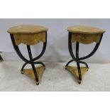 A PAIR OF ART DECO DESIGN WALNUT AND EBONISED OCCASIONAL TABLES each with a shaped top and frieze