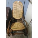 A BENTWOOD ROCKING CHAIR with cane back and seat