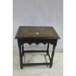 A JACOBEAN DESIGN CARVED OAK OCCASIONAL TABLE the rectangular top raised on baluster supports