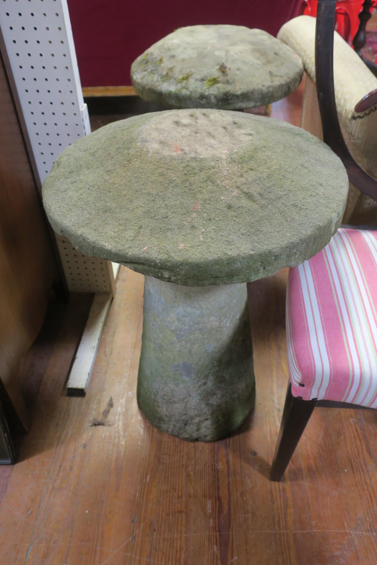 TWO SANDSTONE GARDEN ORNAMENTS each in the form of a mushroom raised on a cylindrical spreading