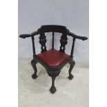 A MAHOGANY CORNER CHAIR the curved back with scroll arms and pierced splat above an upholstered