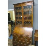 A GEORGIAN DESIGN MAHOGANY BUREAU BOOKCASE the moulded cornice above a pair of astragal glazed