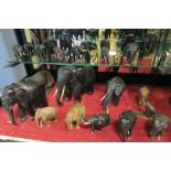 A COLLECTION OF ELEPHANTS to include eight in ebony a brass example etc etc
