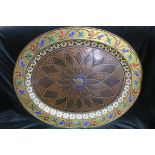 A LARGE ORIENTAL GILT BRASS AND COPPER WALL MOUNTED PLAQUE of oval outline with stylized foliate