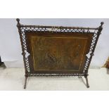 A GOTHIC DESIGN PINE LEATHER AND POLYCHROME FIRE SCREEN the cylindrical and rectangular framed with