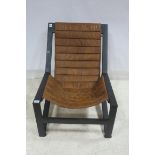 A RETRO METAL FRAME AND HIDE UPHOLSTERED LOUNGE CHAIR with upholstered panel back and seat