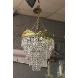 A CONTINENTAL GILT BRASS AND CUT GLASS FIVE TIER CENTRE LIGHT hung with faceted pendants