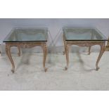 A PAIR OF LIME WOOD AND GLAZED END TABLES each of rectangular form with plate glass top above a