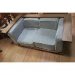 A VINTAGE TEAK FRAME SETTEE with loose cushions on cylindrical legs 65cm (h) x 148cm (w) x 84cm (d)