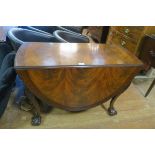 A GOOD CHIPPENDALE DESIGN MAHOGANY DROP LEAF TABLE the oval hinged top with carved rim on cabriole