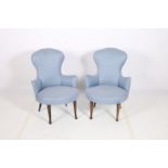 A PAIR OF RETRO UPHOLSTERED TUB SHAPED CHAIRS each with a shaped back and seat on tapering legs