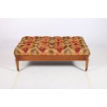 A FINE CHERRYWOOD AND UPHOLSTERED FOOTSTOOL the rectangular deep button upholstered seat above a