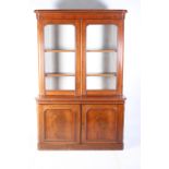 A VICTORIAN MAHOGANY LIBRARY BOOKCASE the outset moulded cornice above a pair of glazed doors