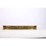 A 19TH CENTURY BRASS FENDER the rectangular bowed outline with applied decoration on platform base