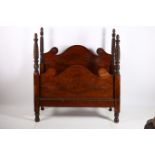 A 19TH CENTURY MAHOGANY FOUR POSTER BED the shaped headboard with applied decoration between spiral