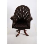 A GOOD HIDE UPHOLSTERED BUTTON BACK SWIVEL OFFICE CHAIR with scroll over arms on revolving base