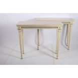 A FINE PAIR OF REGENCY DESIGN POLYCHROME AND GILT MOUNTED CONSOLE TABLES each surmounted with a