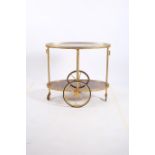 A MAHOGANY AND GILT METAL TWO TIER SERVING TROLLEY of oval outline with pierced gallery 73cm (h) x