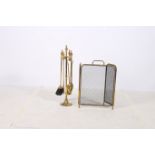 A HEAVY BRASS FOUR PIECE COMPANION SET ON STAND together with a brass and mesh three fold spark