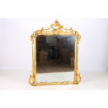 A GOOD 19TH CENTURY GILTWOOD AND GESSO OVERMANTLE MIRROR the rectangular plate within a flower head