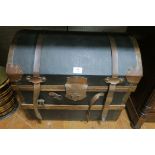 A CANVAS UPHOLSTERED AND COPPER BOUND DOME TOP TRAVELLING TRUNK with timber slats the hinged lid