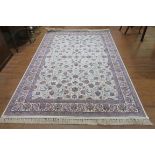 A FINE PERSIAN WOOL RUG the cream ground with central flower filled panel within a conforming