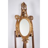 A CONTINENTAL GILT FRAME MIRROR the oval bevelled glass plate within a moulded frame with urn and