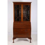 A CHIPPENDALE DESIGN MAHOGANY BUREAU BOOKCASE the dentil moulded cornice above a pair of astragal