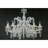 A FINE CONTINENTAL CUT GLASS TEN BRANCH CHANDELIER hung with faceted pendants and drops THE BUYER