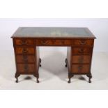 A CHIPPENDALE DESIGN MAHOGANY PEDESTAL DESK the rectangular top with tooled leather inset and