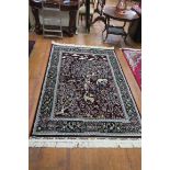 A WINE GROUND PATTERNED RUG the central panel depicting tree of life within a foliate and flower